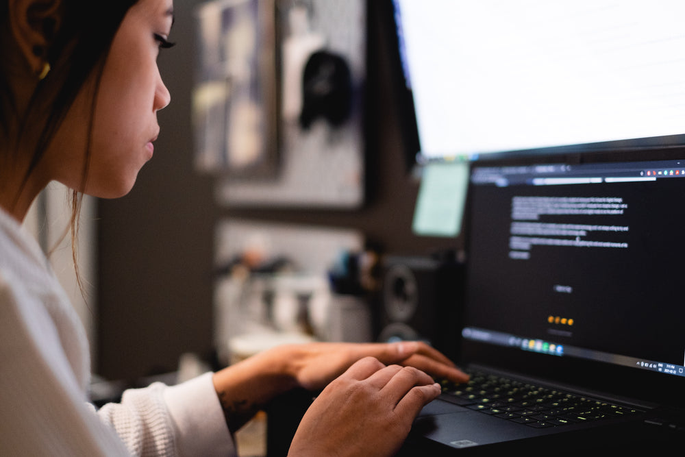 woman focuses on a computer for work