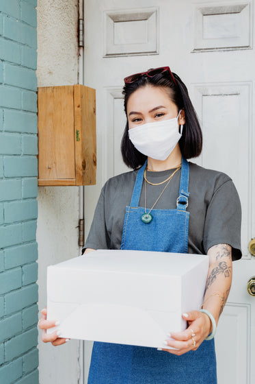 woman folding box for curb side pickup