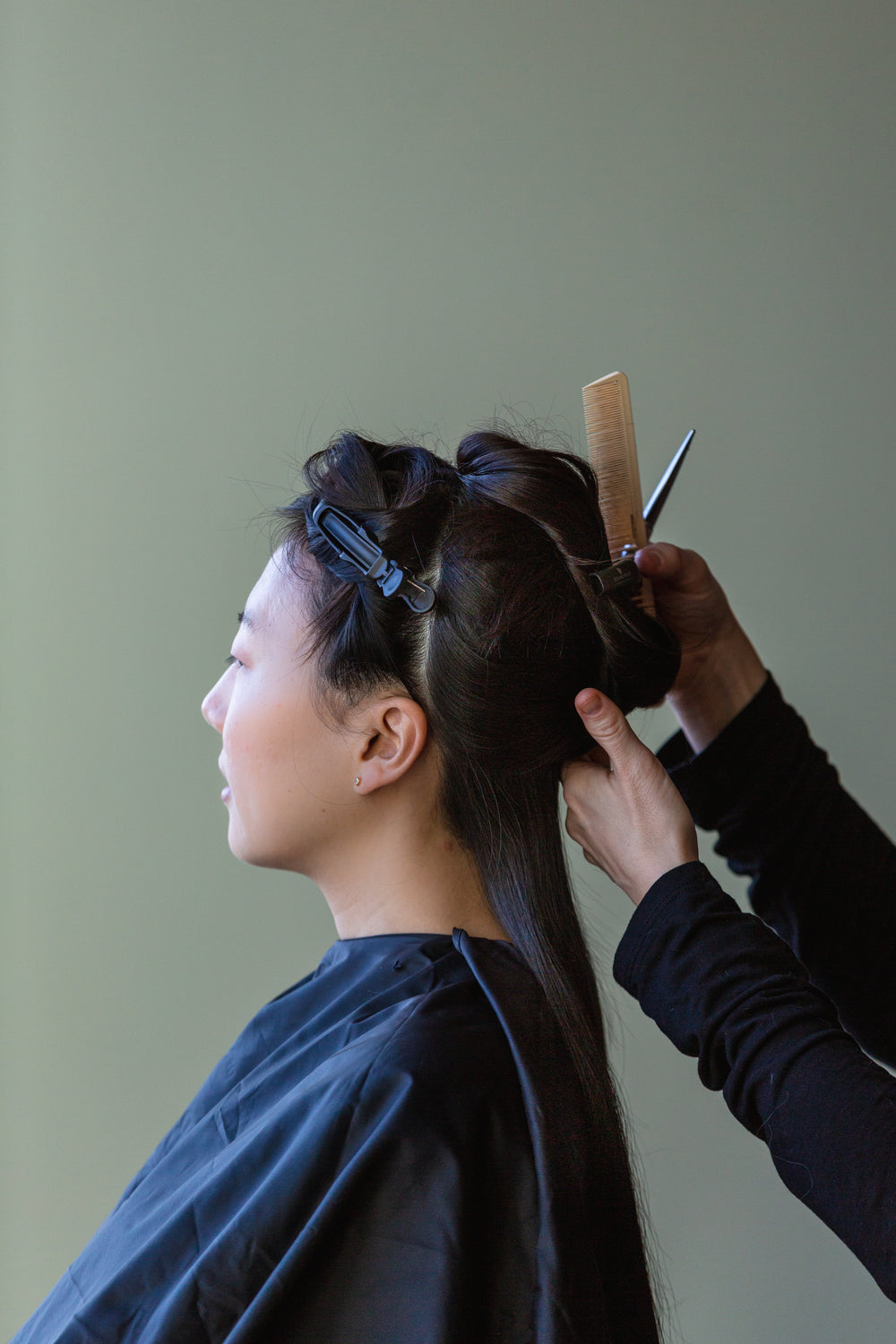 woman gets hair styled