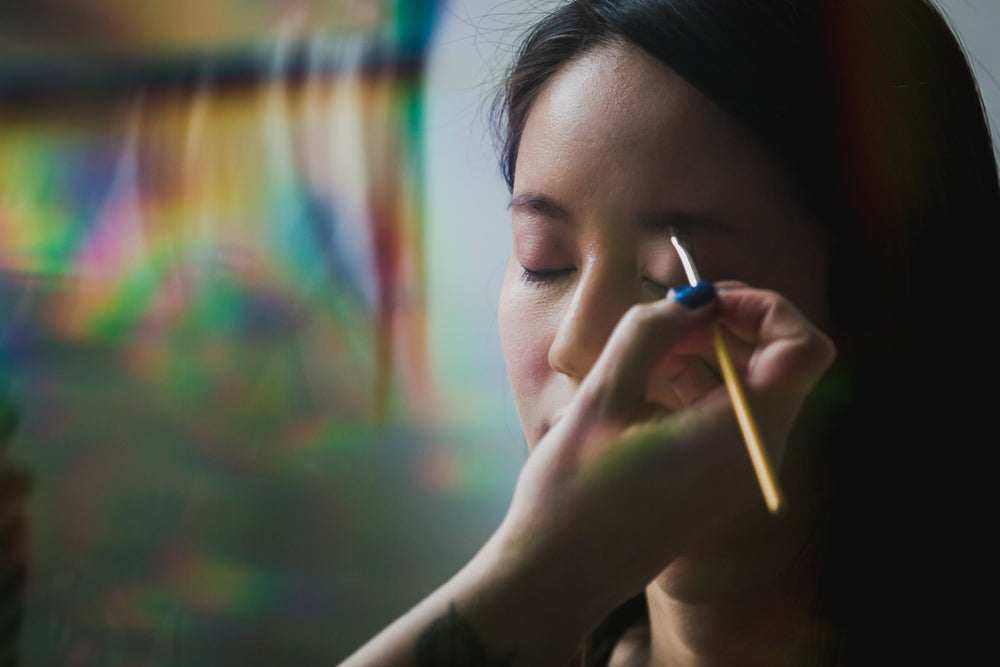 woman getting eye makeup