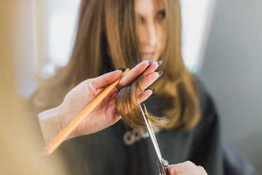 woman getting hair cut at salon