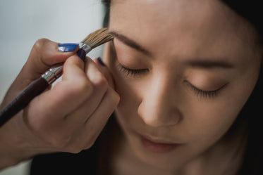 woman getting makeup applied