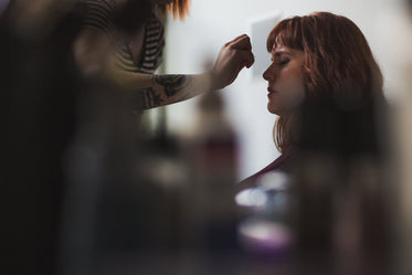 woman getting makeup done