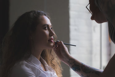 woman getting makeup in natural light