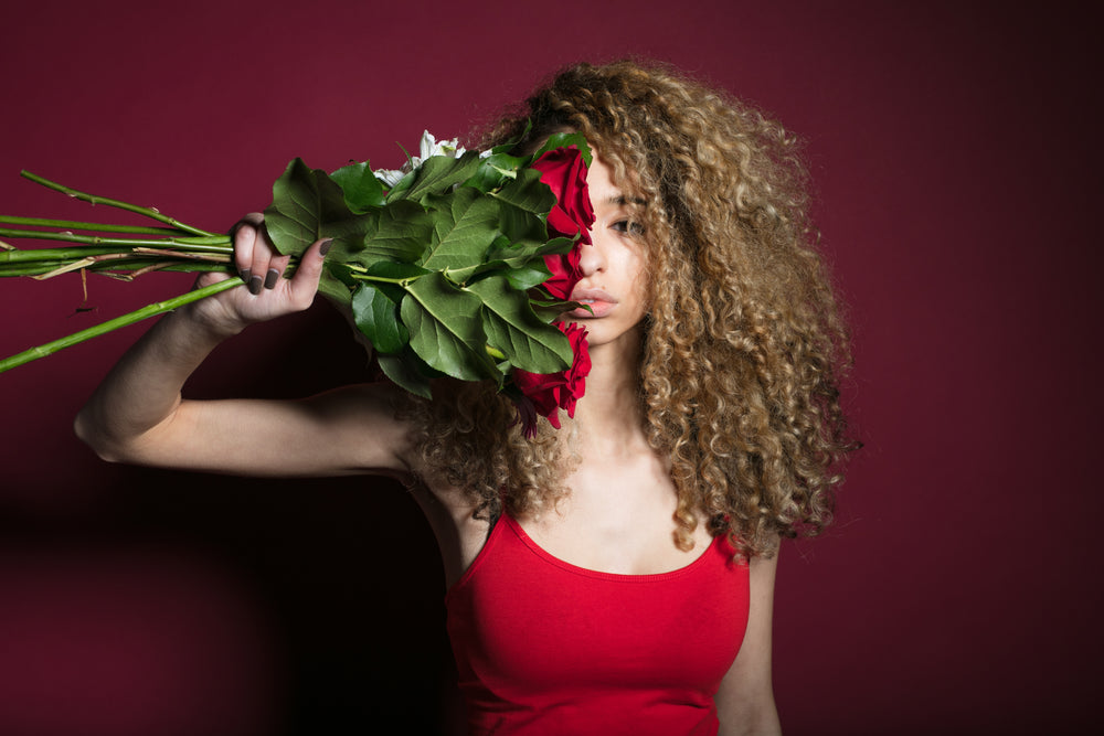 woman grasping flowers