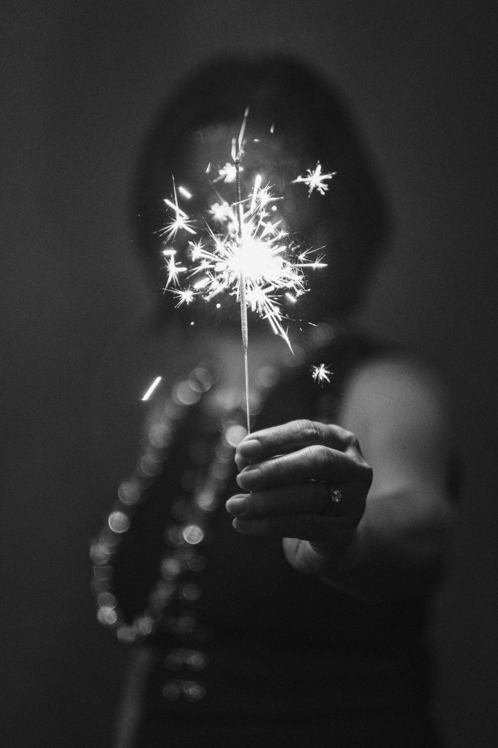 woman holding a sparkler celebrating 2021