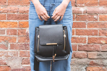 woman holding black fashion bag