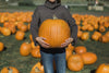 woman holding perfect pumpkin
