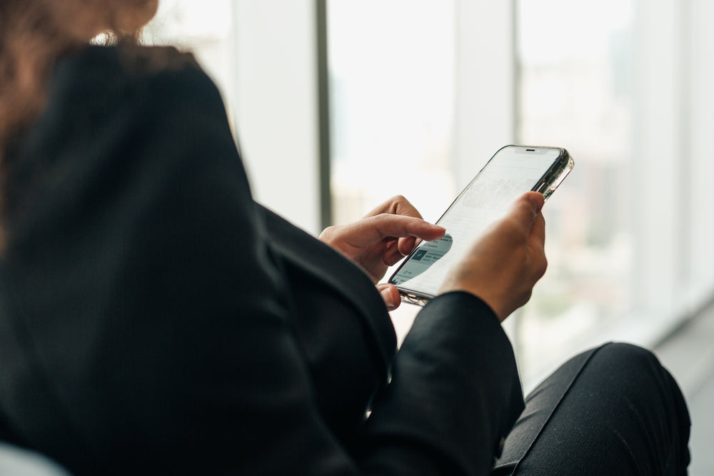 woman holding phone browsing social media