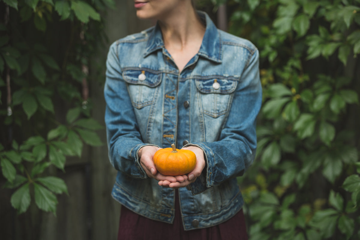 woman holding small pumpkin