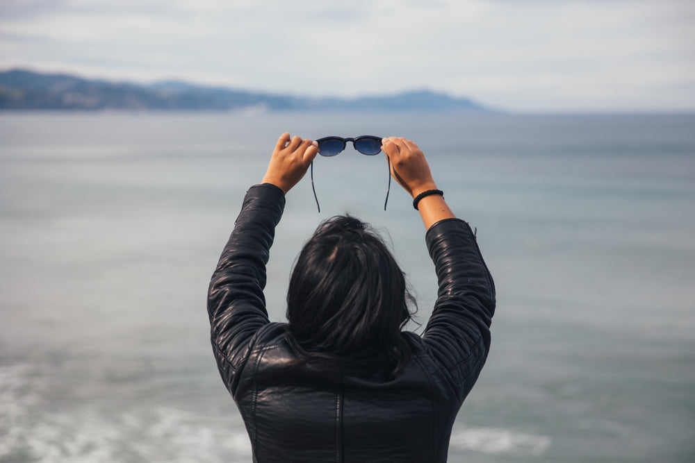 woman holding sunglasses