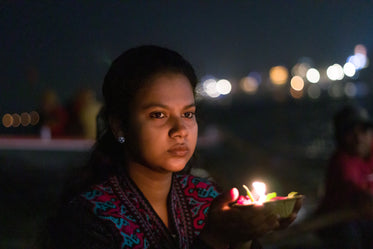 woman holds candle