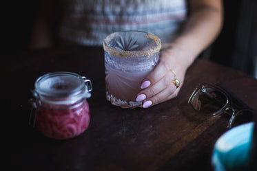 woman holds cocktail glass