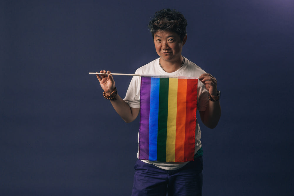 woman holds pride flag and smirks