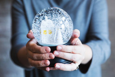 woman holds snow globe