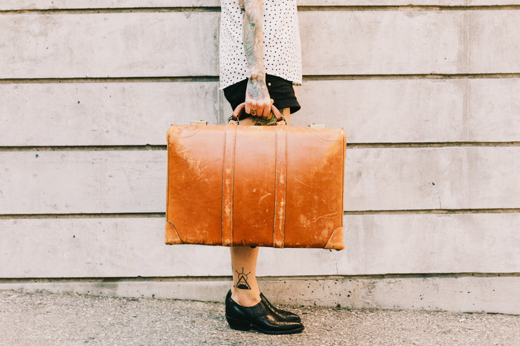 woman-holds-vintage-suitcase.jpg?width=746&format=pjpg&exif=0&iptc=0
