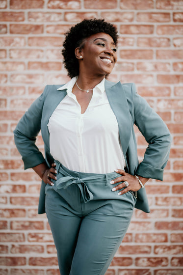 woman in a blue suit smiles and poses for the camera