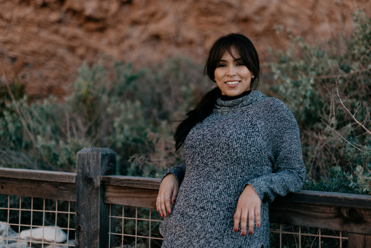 woman-in-a-sweater-smiles-as-she-leans-against-a-fence.jpg?width=746&format=pjpg&exif=0&iptc=0