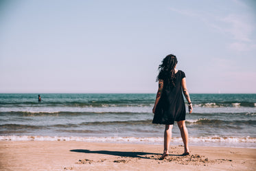 woman in black dress at beach