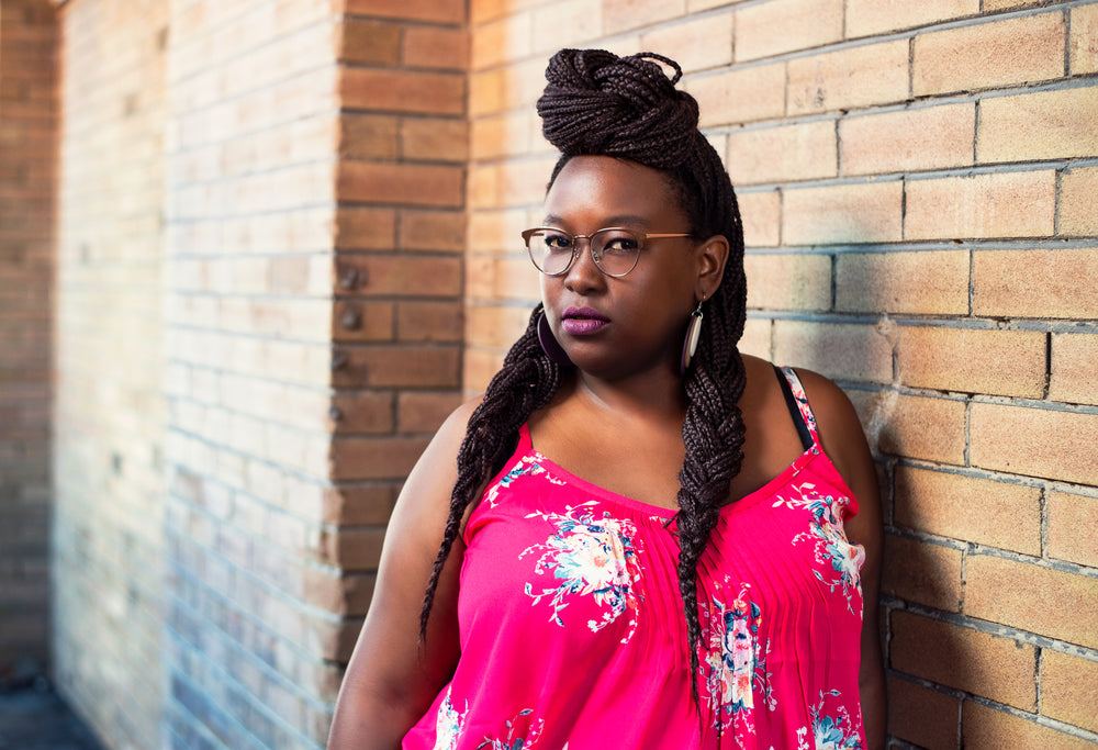 woman in braids and floral blouse