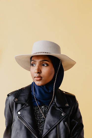 woman in cowboy hat and leather jacket