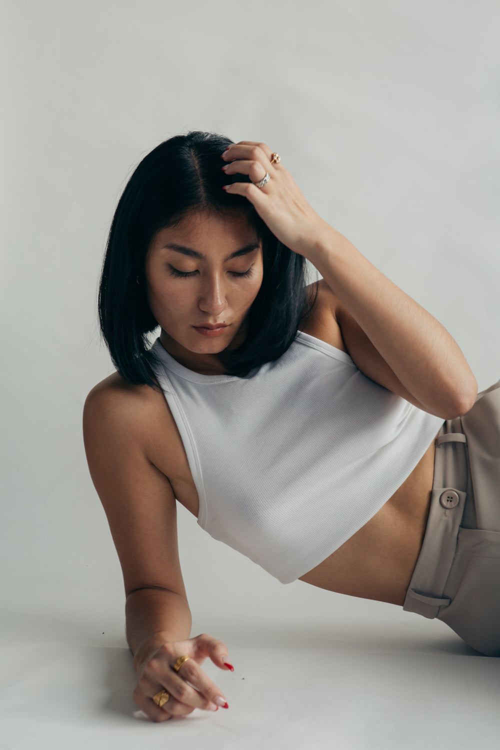 woman in cropped white vest top