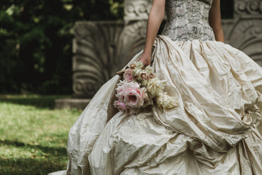 woman in dress holding bouquet