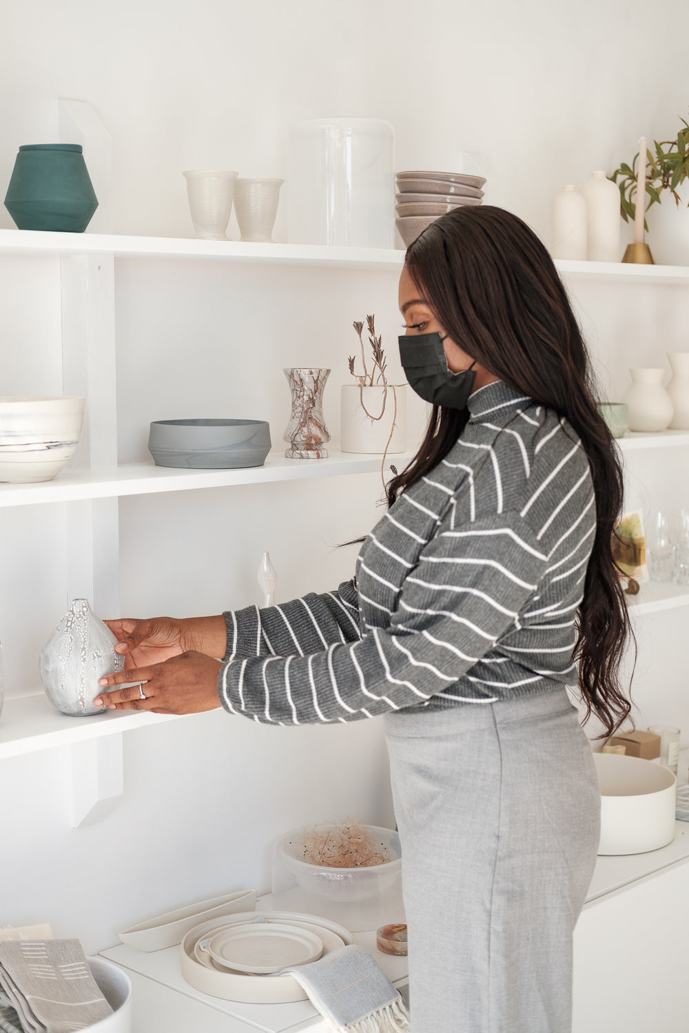 woman in face mask picks up a product