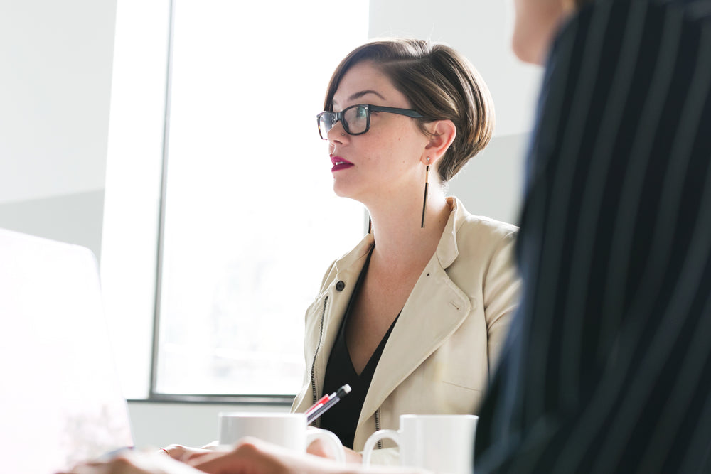 woman in glasses at meeting