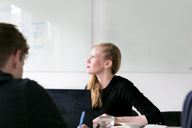 woman in office looks out window