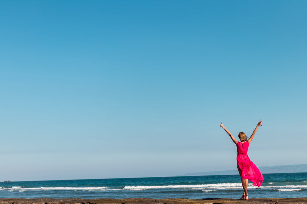 woman in red by the sea