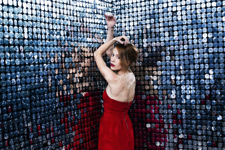 woman-in-red-dress-stretches-out-arms-against-a-wall-of-mirrors.jpg?width=746&format=pjpg&exif=0&iptc=0