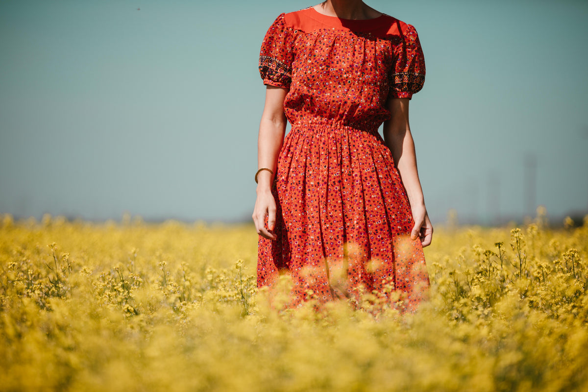 woman in red in yellow field
