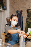 woman in retail store sanitizing her hands