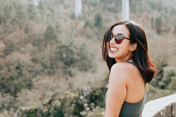 woman-in-round-sunglasses-smiles-wide.jp