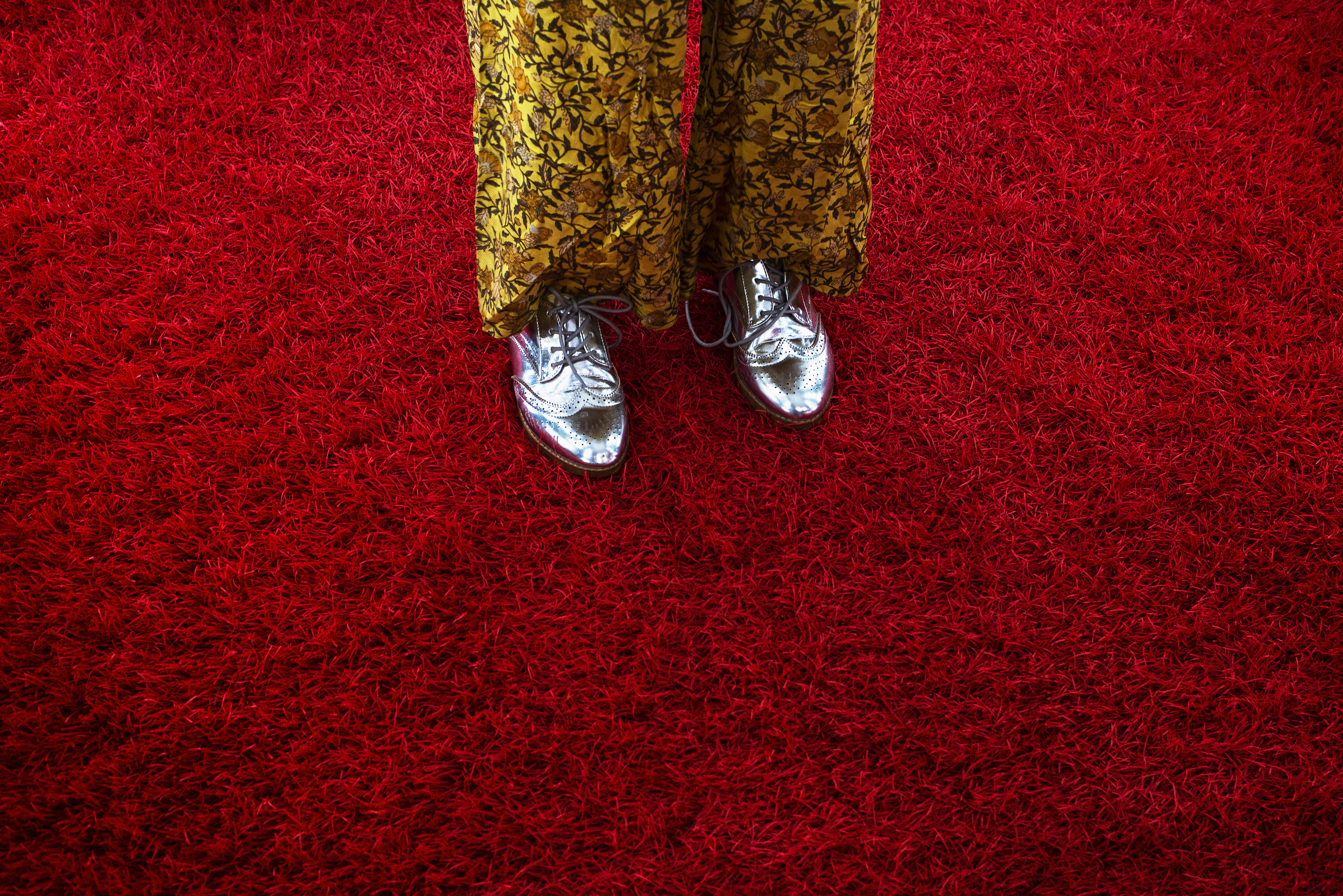 Woman In Silver Oxfords Crossing Red Shag Carpet