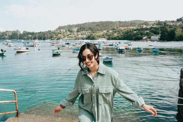 woman in sunglasses walks towards the camera