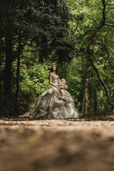 woman in the woods holding bouquet