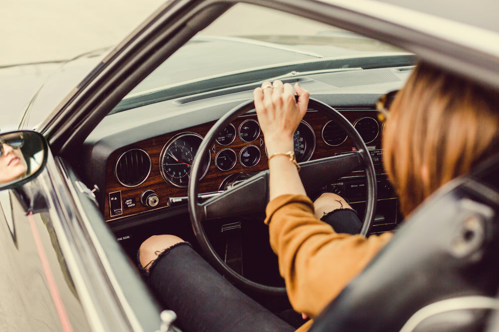 woman in vintage car