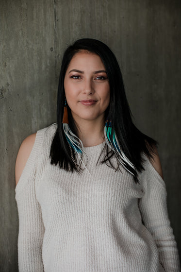 woman in white sweater looks into camera lens