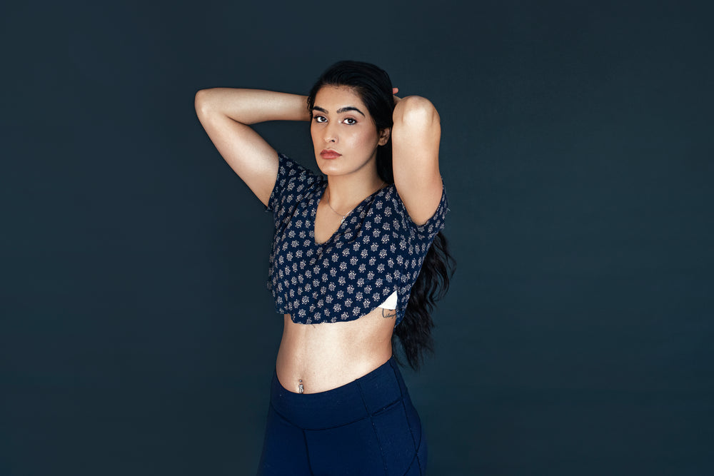 woman in yoga attire pulling hair back