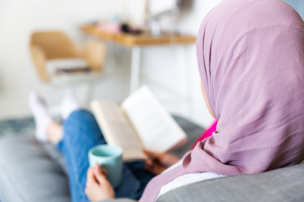 woman kicks back with book and coffee