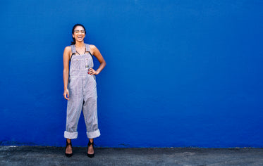 woman laughing and posing by blue wall