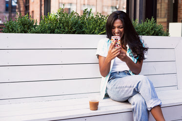 woman laughs at mobile phone