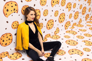 woman leans against the wall of a cookie-themed room