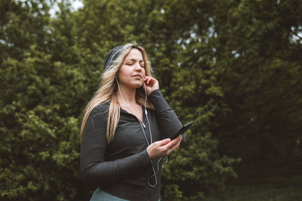 woman listening to music closes her eyes in enjoyment