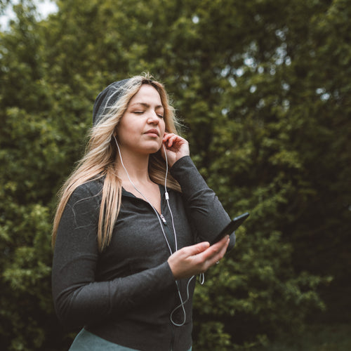 Woman Listening To Music Closes Her Eyes In Enjoyment