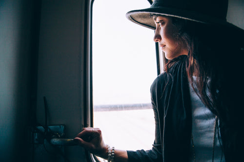 woman looks out train window