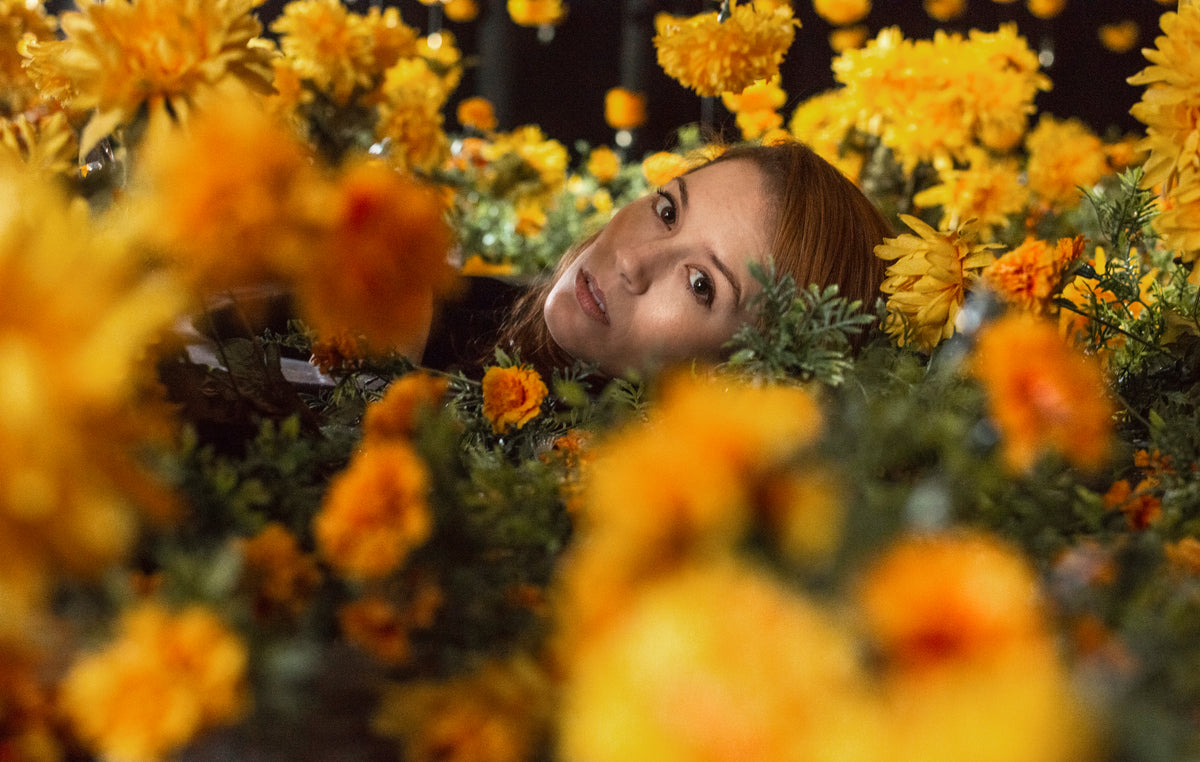 woman lying in yellow flowers