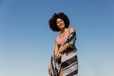 woman models against blue sky